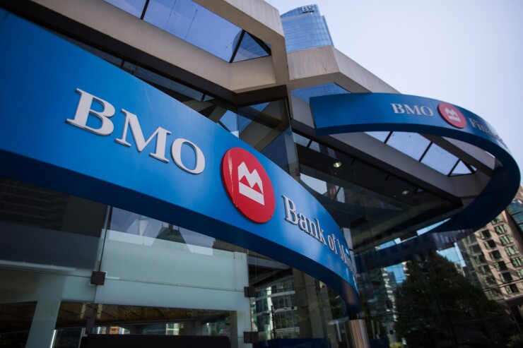 Bank of Montreal signage is displayed outside a branch in Vancouver.